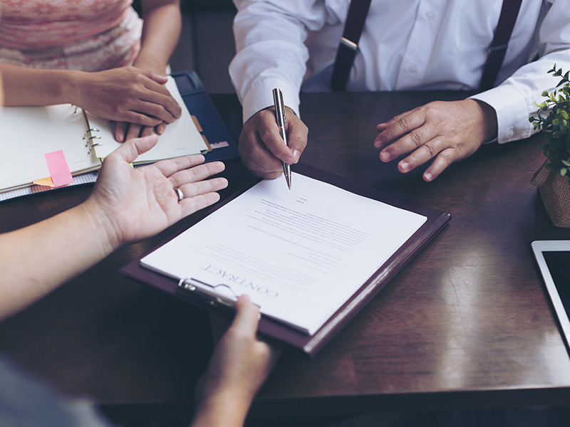 three people in meeting signing documents daytona beach fl